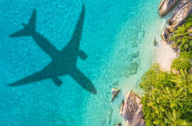 istock Travel concept with airplane shadow and beach 1165375578