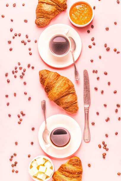 istock Coffee and croissants on pastel background 1165375603