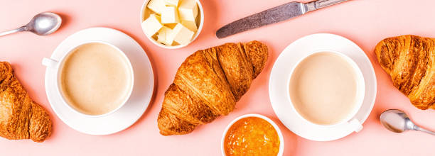 istock Coffee and croissants on pastel background 1165375642