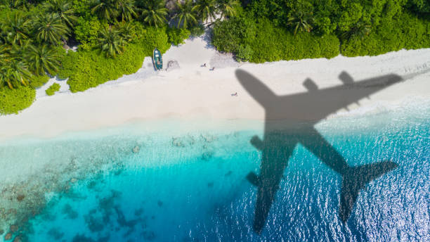 istock Travel concept with airplane shadow and beach 1165375756