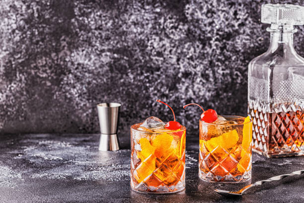 istock Old fashioned cocktail with cherries and orange twist 1165375773