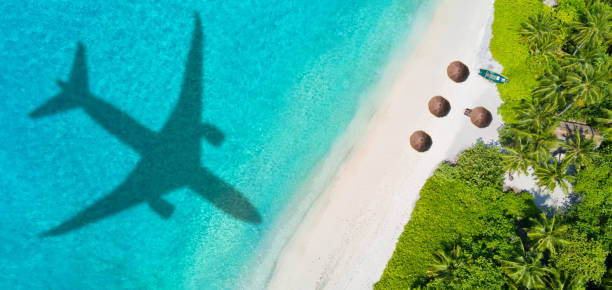 istock Travel concept with airplane shadow and beach 1165376294