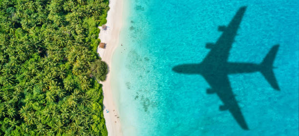 istock Travel concept with airplane shadow and beach 1165376335