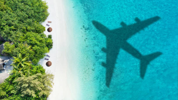 istock Travel concept with airplane shadow and beach 1165376346