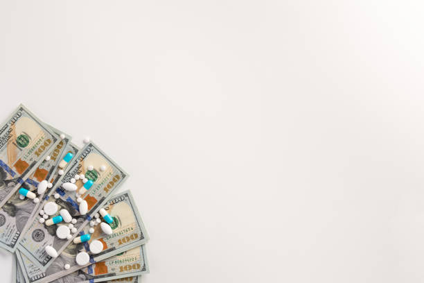 istock Pills and capsules isolated on white background with money 1165376839