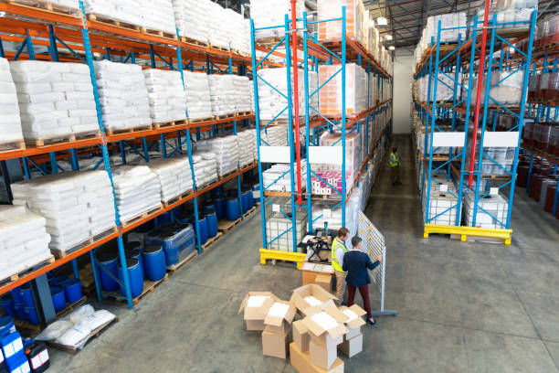 istock Warehouse staff discussing over whiteboard in warehouse 1165377108