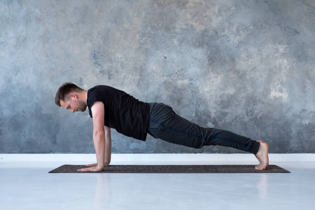 istock Sport caucasian young man doing full plank. 1165379573