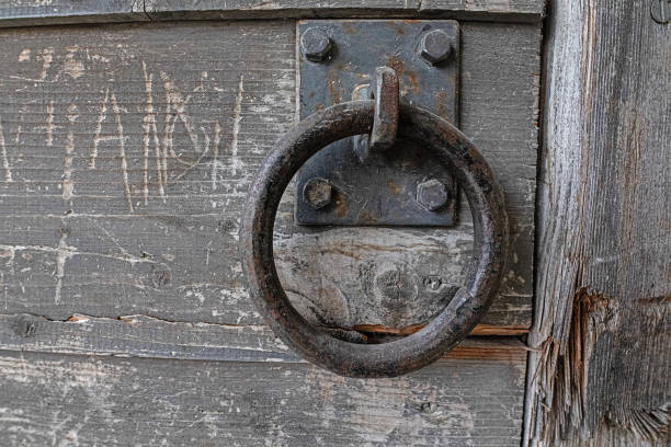 istock Sturdy iron ring on old wooden door 1165382448