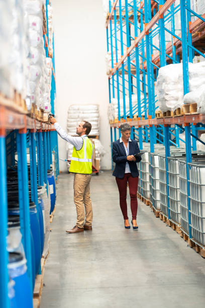 istock Male worker scanning package with barcode scanner in modern warehouse 1165382666