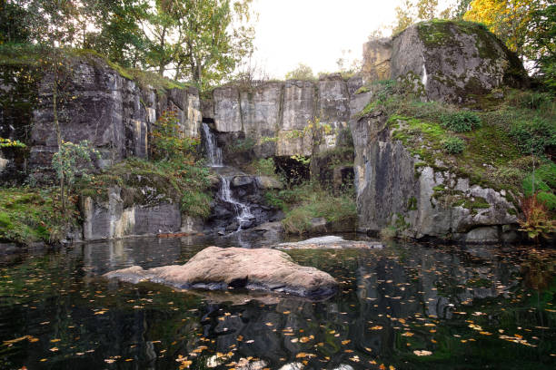 istock Rocky with a small waterfall and a lake. 1165383397