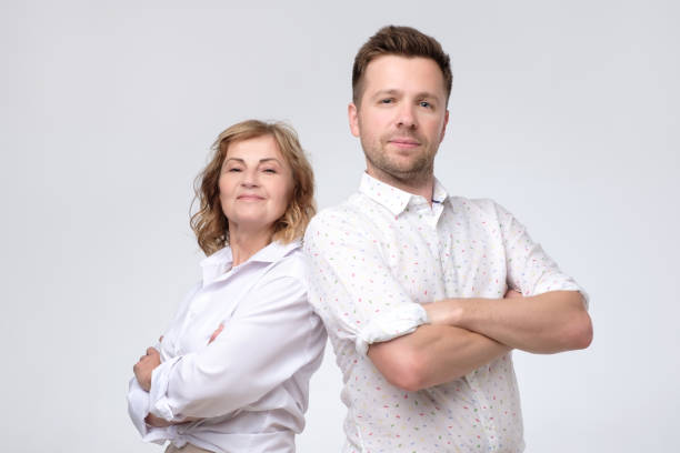 istock Man and woman standing back to back 1165383819