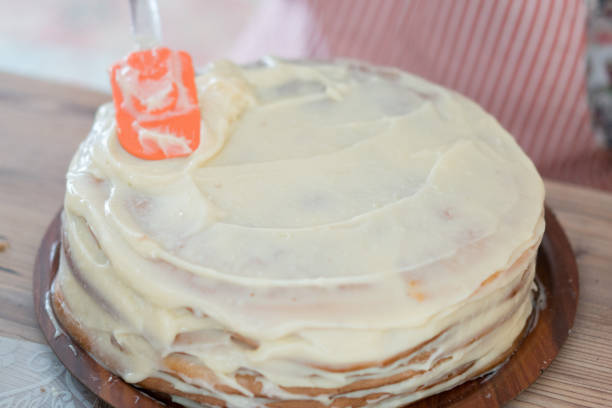 istock Woman decorating a delicious cake 1165384798
