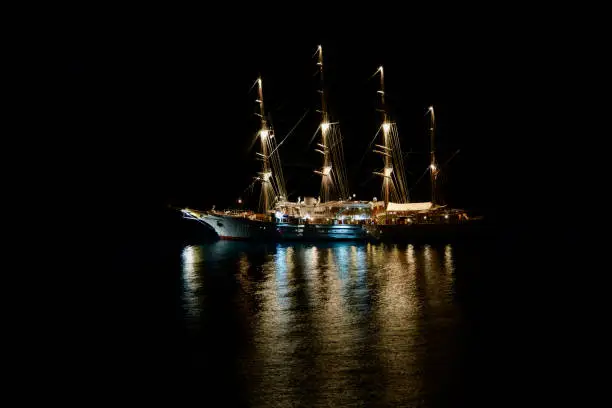 Closeup of an Illuminated four-master sailing boat by night