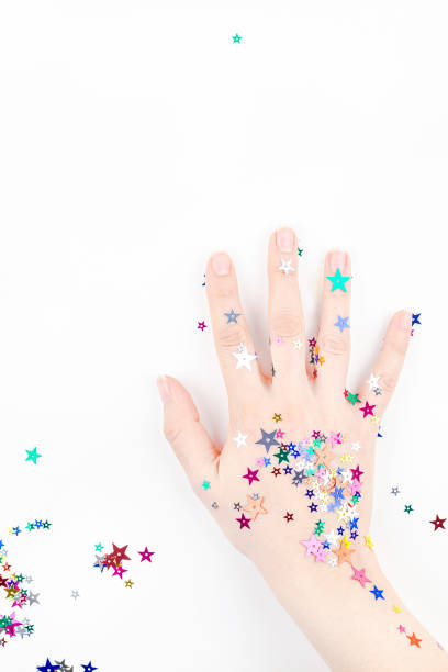 istock Woman hand with festive color star confetti 1165390507