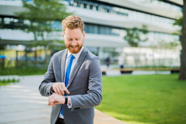 istock Happy young businessman using a smart watch. 1165391179