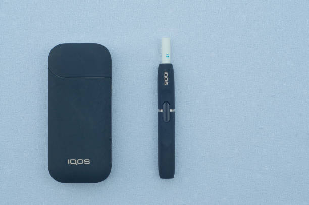 IQOS electronic cigarette with heat-not-burn system Caslano, Ticino, Switzerland - 26th July 2019 : Picture of IQOS a new heat-not-burn tobacco product technology produced by Philip Morris International in Neuchatel, Switzerland iqos e cig stock pictures, royalty-free photos & images