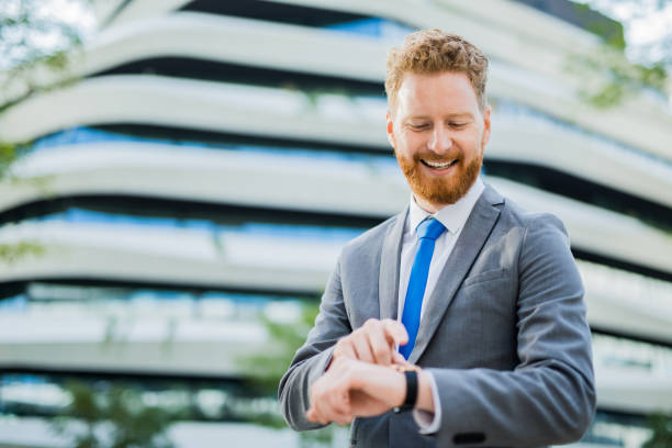 istock Happy young businessman using a smart watch. 1165391673