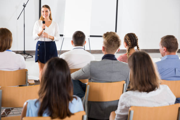istock Female coach giving presentation for audience 1165393235