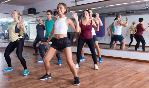 Young happy dansers studying zumba elements Young happy dansers studying zumba elements in dancing class zumba image stock pictures, royalty-free photos & images