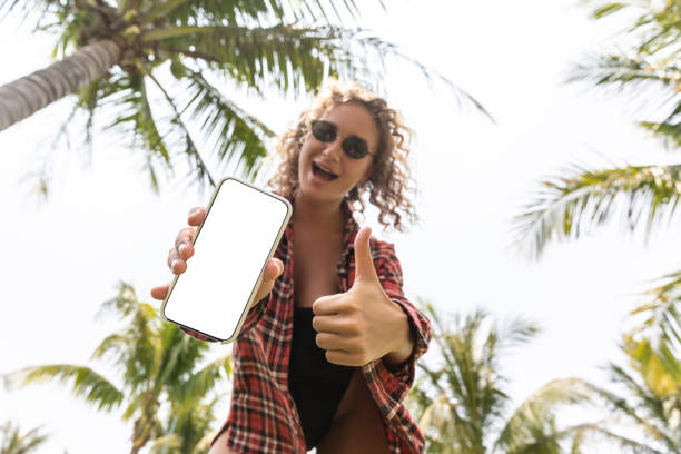 istock Girl showing someting on  smartphone display and says okey 1165397921