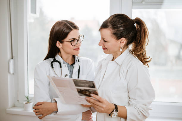 istock Two beautiful female doctors inspecting test results. 1165399703