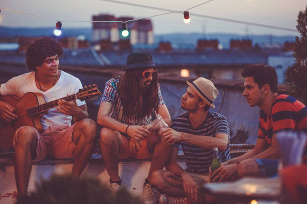 istock Male friends enjoying at rooftop 1165399725