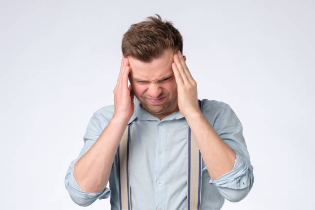 istock Have some troubles. Young caucasian man with headache 1165400150