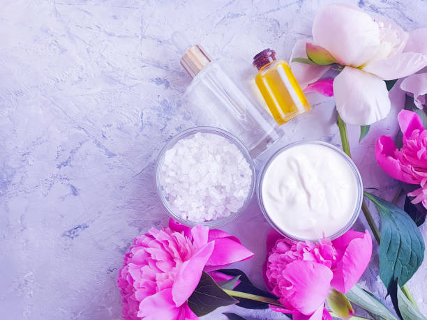 istock cosmetic cream,  , peony flower on a gray concrete background 1165401242