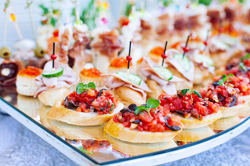 Beautifully decorated catering banquet with different food snacks and appetizers