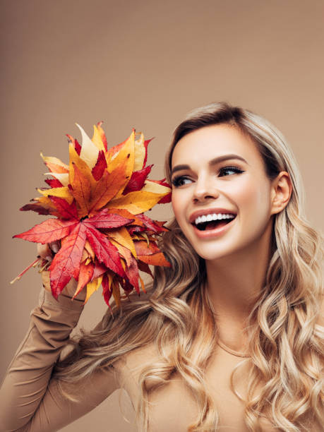 istock Beautiful girl with autumn leaf 1165402231