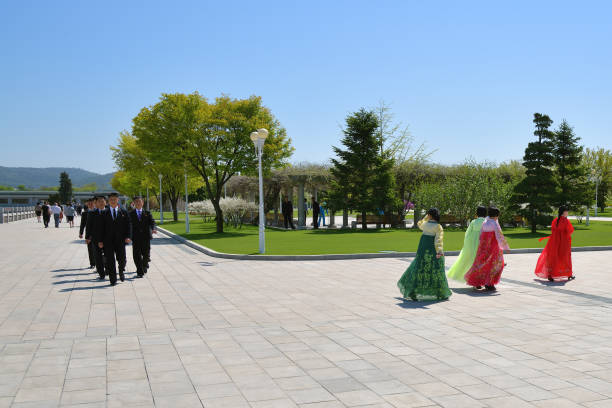 Pyongyang, North Korea. People Pyongyang, North Korea - May 2, 2019: People in the territory of the Kumsusan Memorial Palace of the Sun. Mausoleum and tomb of Kim Il Sung and Kim Jong Il. kim il sung mausoleum stock pictures, royalty-free photos & images