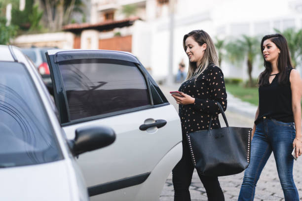 istock Businesswomen entering driver service by app 1165408666