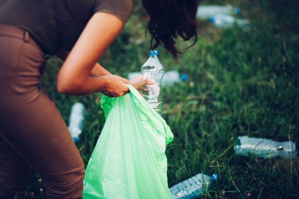 istock Woman Picking Up Trash in Rural 1165409555
