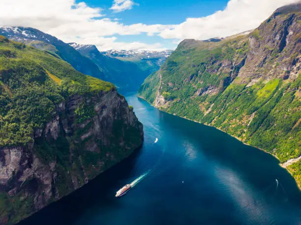 Fjord Geirangerfjord with ferry boat, view from Ornesvingen viewing point, Norway. Travel destination