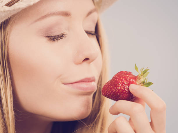 istock Young woman with fresh strawberry 1165417185