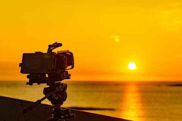 istock Camera take photo at sunset over sea 1165417848
