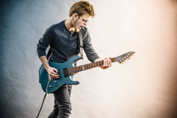 istock Young man playing electric guitar 1165418653