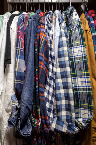 istock Assorted Men's Shirts Hanging in a Closet 1165422041
