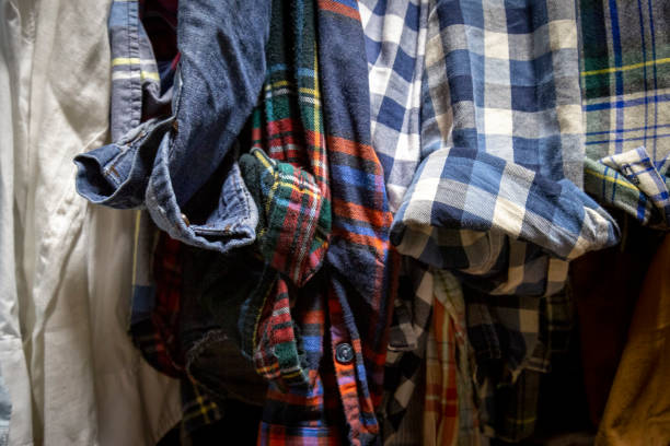 istock Assorted Men's Shirts Hanging in a Closet 1165422049