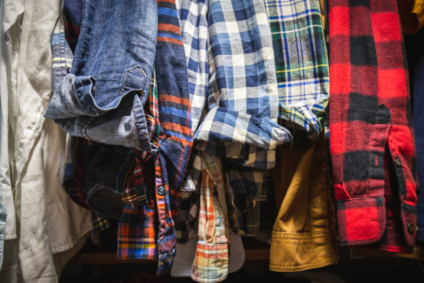 istock Assorted Men's Shirts Hanging in a Closet 1165422050