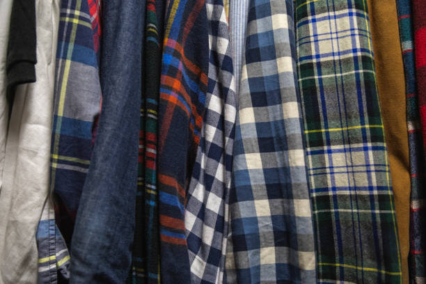 istock Assorted Men's Shirts Hanging in a Closet 1165422052
