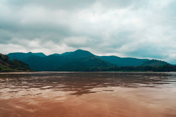 landscape of the mekong river coast in asia. mountain in clouds. landscape of laos. - luang phabang laos thailand mekong river imagens e fotografias de stock