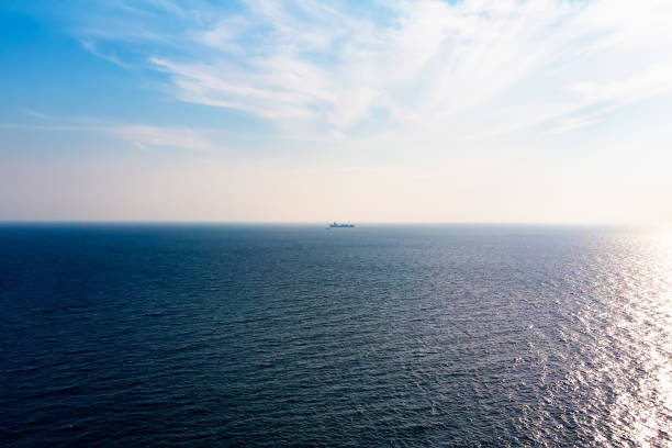 istock Ocean view in sunny summer day. Cargo boat on horizon. 1165422327