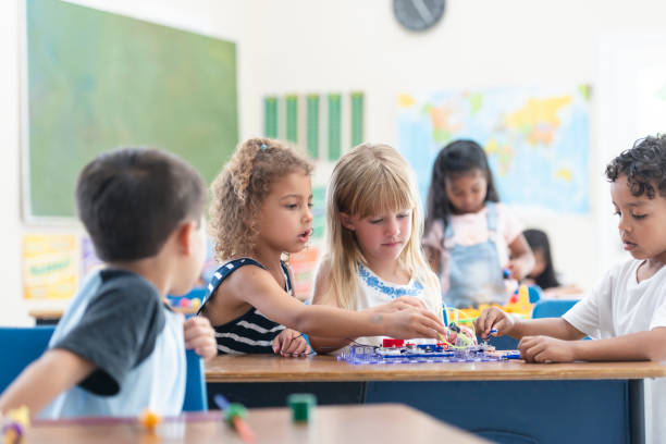 istock Two (2) Schoolgirls Working Together on a Classroom Activity 1165422383