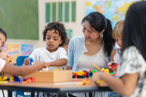 istock Young Asian Teacher Helps Her Male Student 1165422389