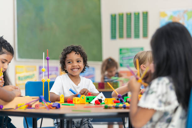 istock Adorable Little Kindergarten Boy Doing an In-Class Activity 1165422390