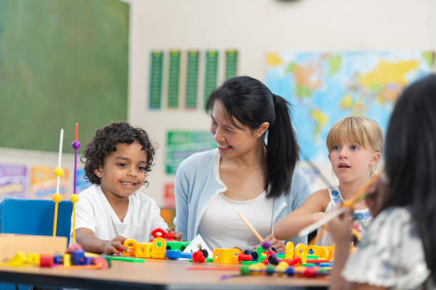 istock Young Asian Teacher Helps Her Male Student 1165422395