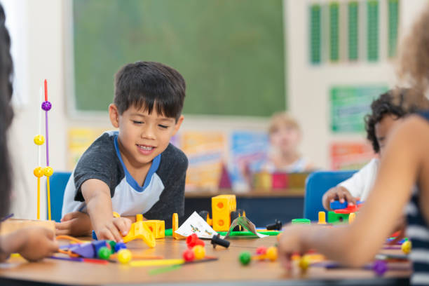 istock Adorable Little Kindergarten Boy Doing an In-Class Activity 1165422397