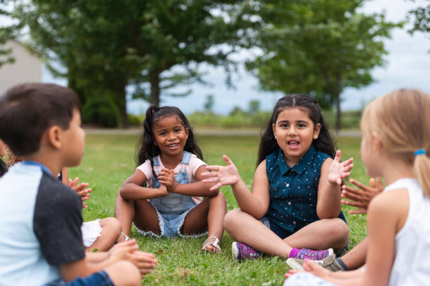 istock A Multi-Ethnic Group of Young Children are Clapping Outside 1165422406