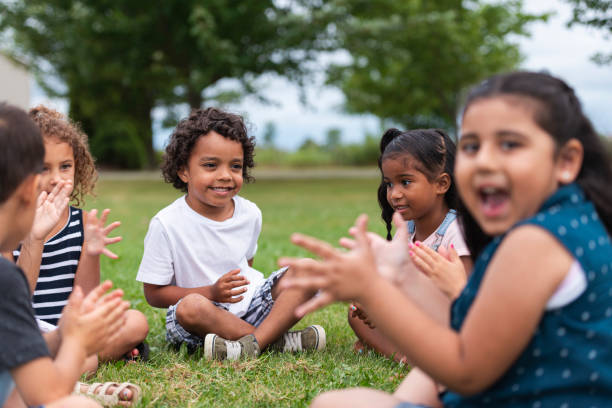 istock A Multi-Ethnic Group of Young Children are Clapping Outside 1165422412